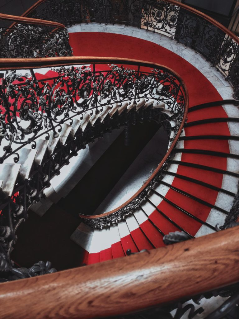 A birds-eye view of a dark spiral staircase